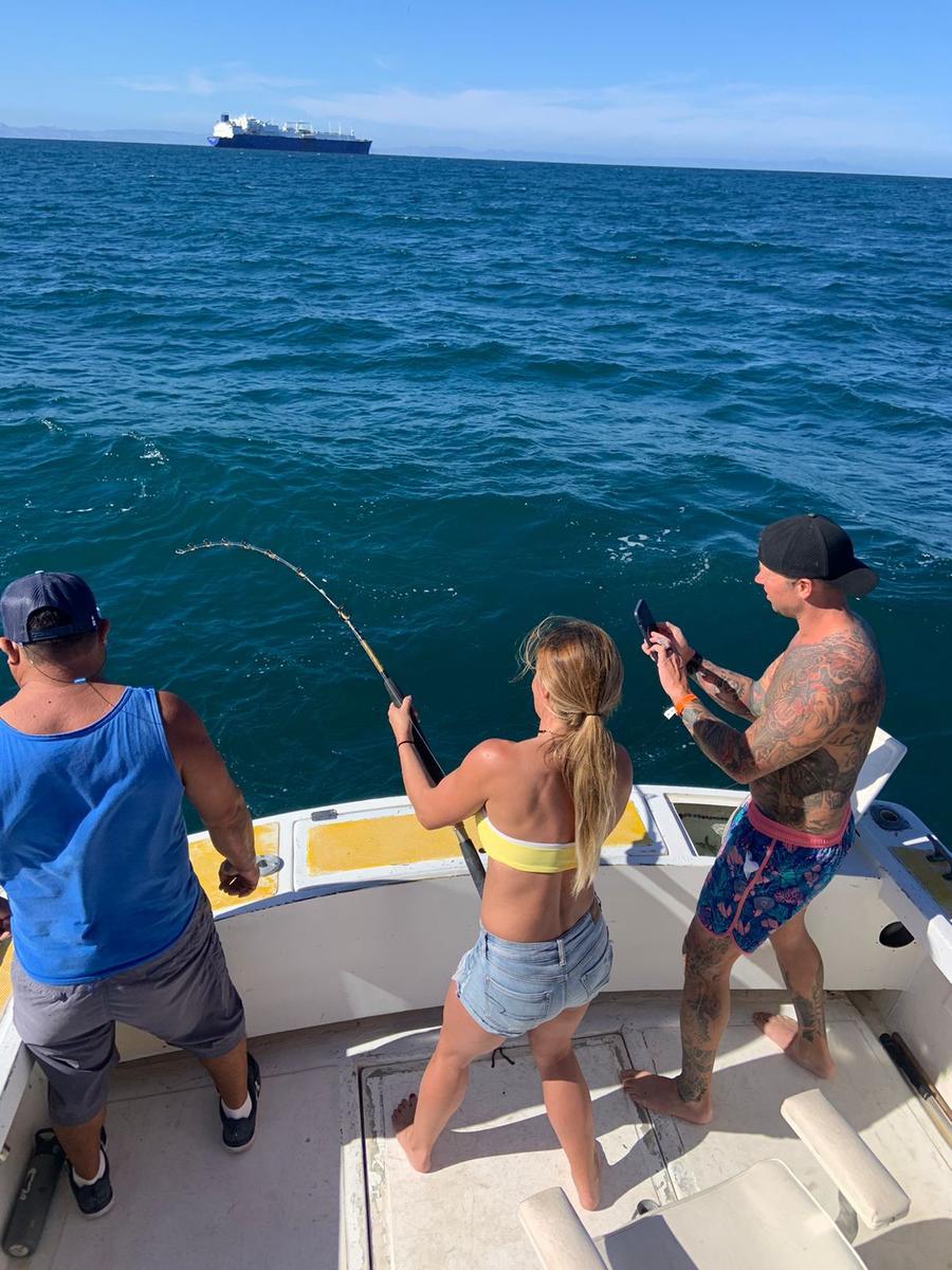 Angler fighting a fish aboard a Baja Mosquito Fleet panga